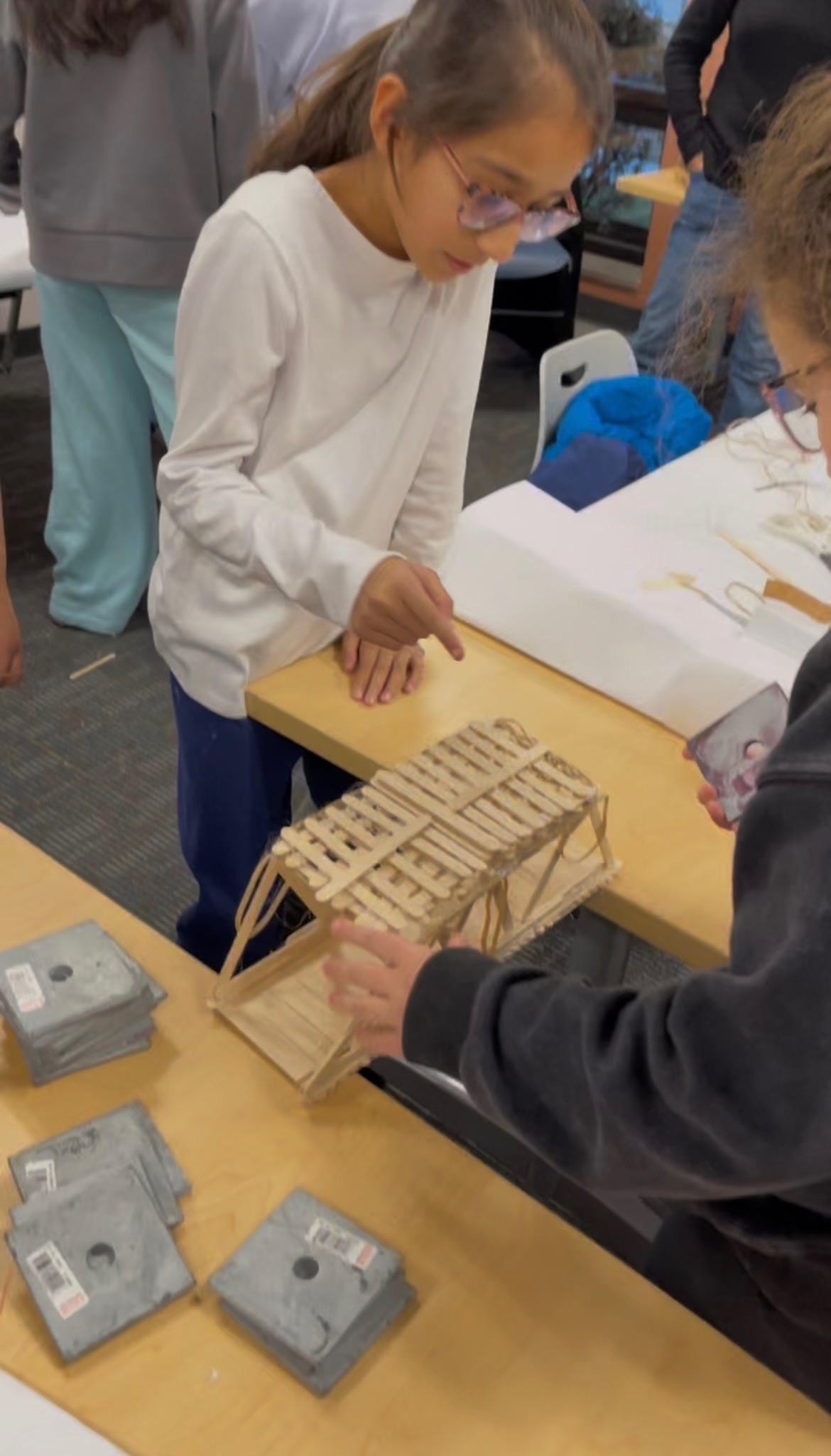 Students learning engineering concepts during a building workshop